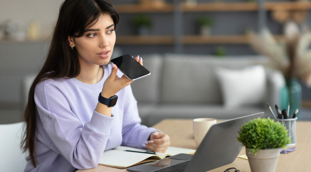 Woman using Lexacom Echo voice recognition software on smart phone