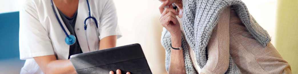 An advanced nurse practitioner explaining notes to a patient